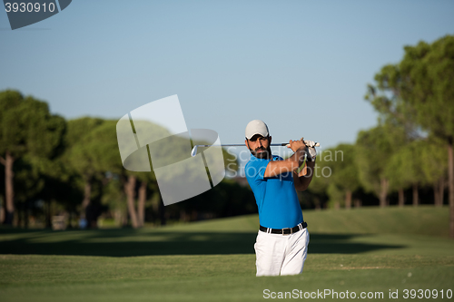 Image of pro golfer hitting a sand bunker shot