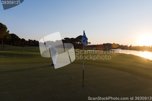 Image of golfer hitting ball to hole