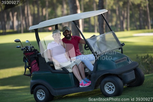 Image of couple in buggy on golf course