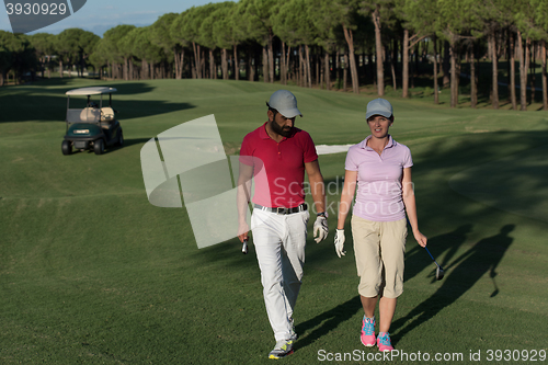 Image of couple walking on golf course