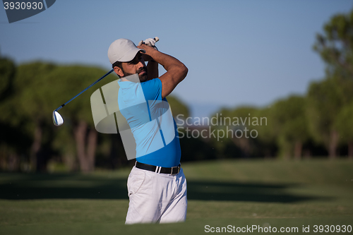 Image of pro golfer hitting a sand bunker shot