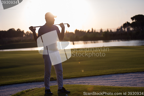 Image of golfer  portrait at golf course on sunset