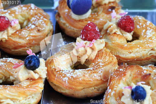 Image of cream puff with raspberries and blueberries