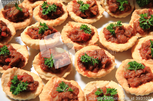 Image of raw meat with salted cookies