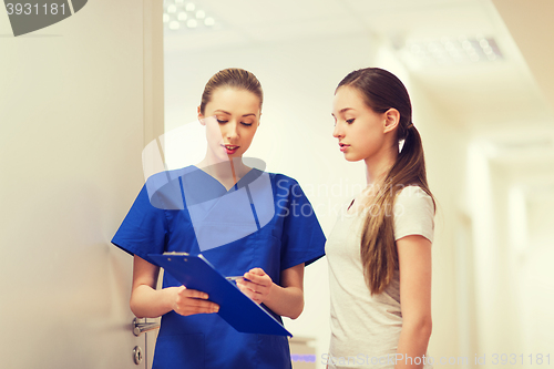 Image of doctor or nurse with clipboard and girl patient