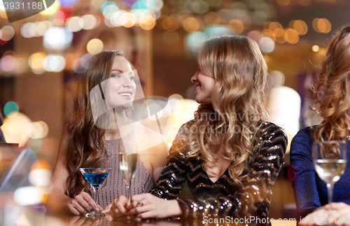 Image of happy women with drinks at night club