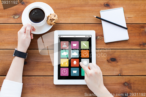 Image of close up of woman with tablet pc on wooden table