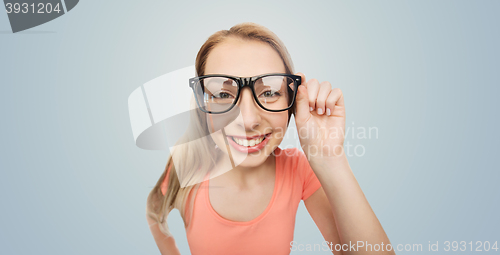 Image of happy young woman or teenage girl in eyeglasses