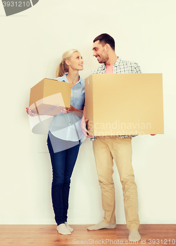 Image of couple with cardboard boxes moving to new home