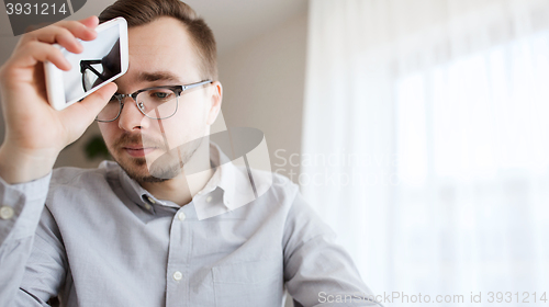 Image of businessman with smarphone at home office