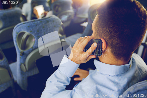 Image of man with smartphone and laptop in travel bus