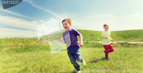 Image of happy little boys running outdoors