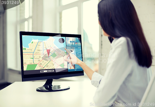 Image of close up of woman with navigator map on computer