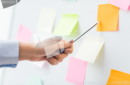 Image of close up of hand pointing to sticker on flip chart