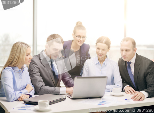 Image of business team with laptop having discussion