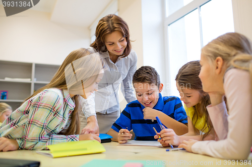 Image of group of school kids writing test in classroom