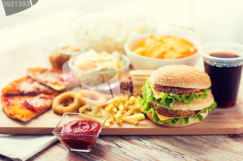 Image of close up of fast food snacks and drink on table