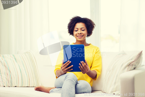 Image of happy african american woman with tablet pc