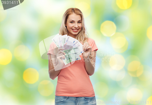 Image of happy young woman with euro cash money