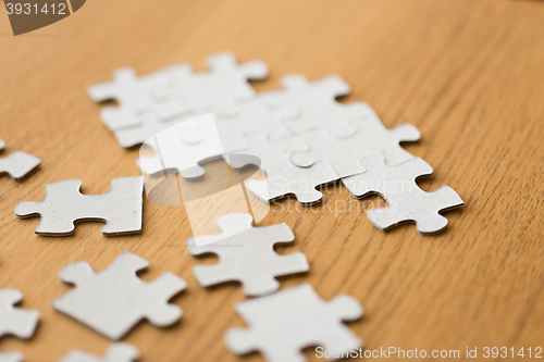 Image of close up of puzzle pieces on wooden surface