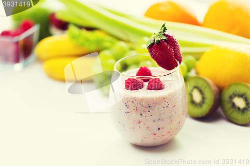 Image of close up of glass with milk shake and fruits