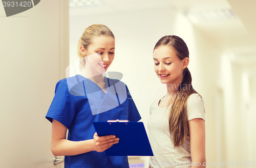 Image of doctor or nurse with clipboard and girl patient