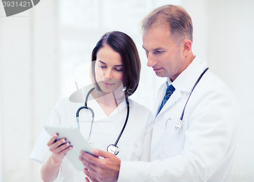 Image of two doctors looking at tablet pc