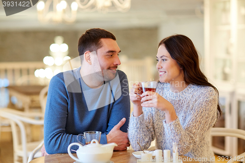 Image of happy couple drinking tea at cafe
