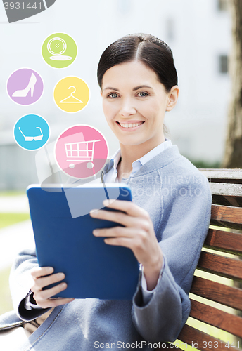 Image of smiling business woman with tablet pc in city