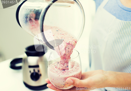 Image of close up of woman with blender and shake at home