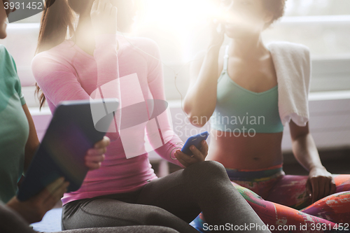 Image of close up of happy women listening to music in gym