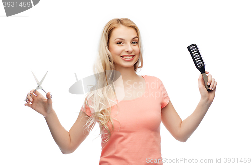 Image of young woman with scissors and hairbrush