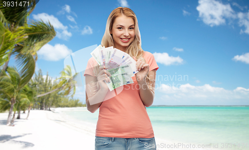 Image of happy young woman with euro cash money