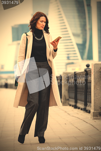 Image of woman messaging with smartphone