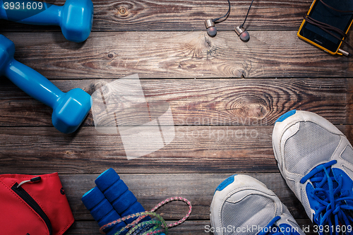 Image of Sport stuff on wooden table, top view