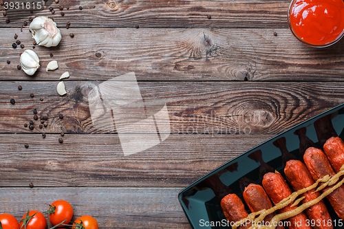 Image of Sausage roasted on the grill.