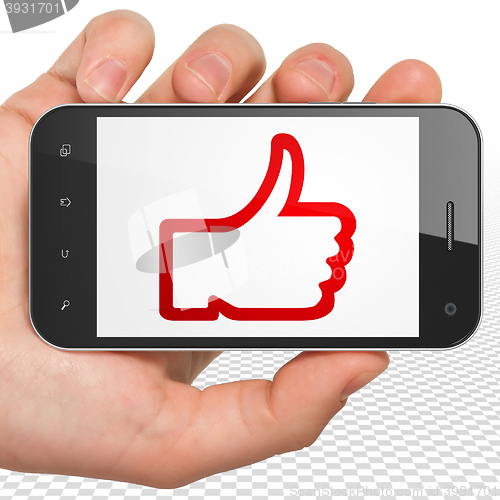 Image of Social network concept: Hand Holding Smartphone with Thumb Up on display