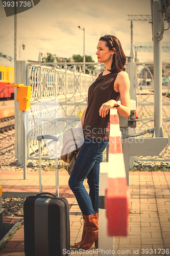 Image of beautiful middle aged woman traveller with suitcase