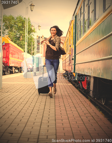 Image of woman with luggage on the station platform