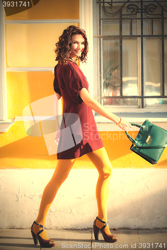 Image of fashion. beautiful middle-aged woman in a stylish burgundy dress