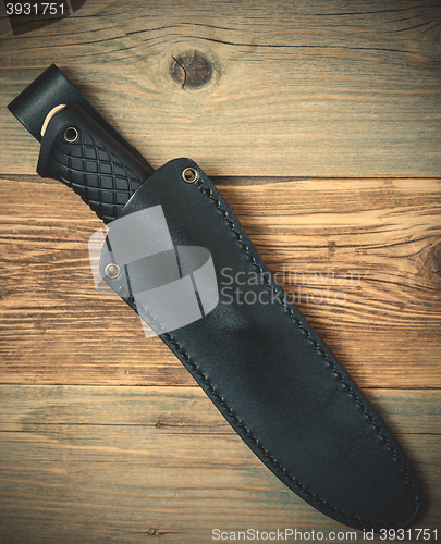 Image of hunting knife in a leather scabbard