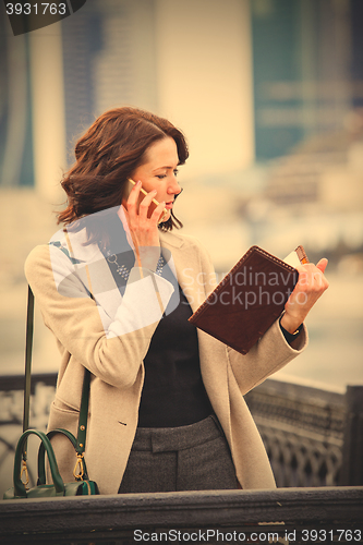 Image of Woman talking on cell phone