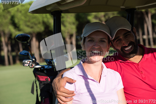 Image of couple in buggy on golf course