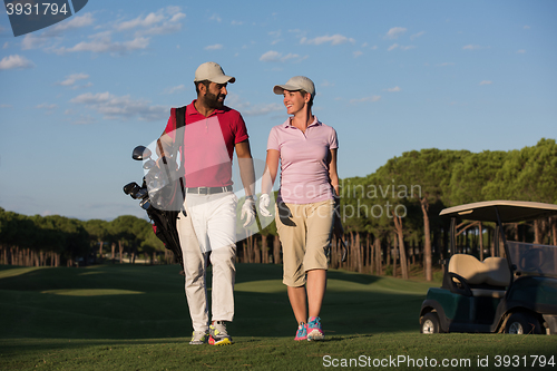 Image of couple walking on golf course