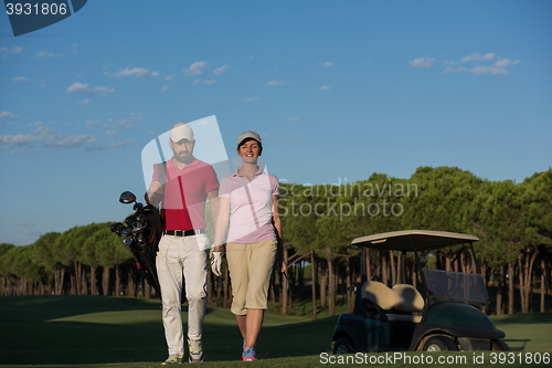 Image of couple walking on golf course