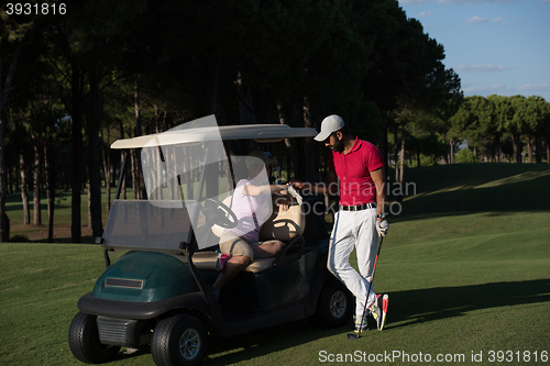 Image of couple in buggy on golf course