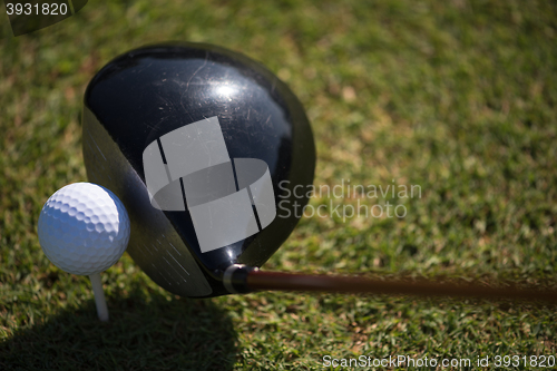 Image of top view of golf club and ball in grass