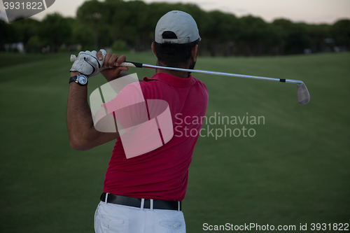 Image of golfer hitting a sand bunker shot on sunset