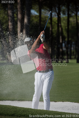 Image of golfer hitting a sand bunker shot