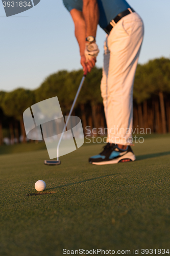 Image of golfer  hitting shot at golf course